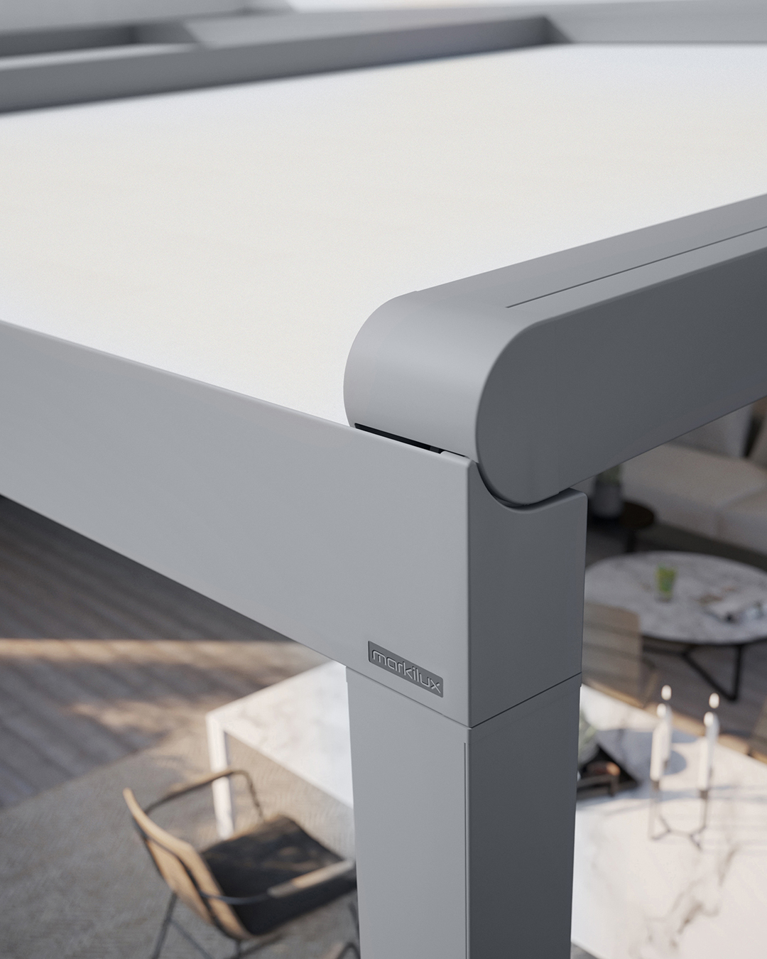Markilux Pergola Stretch close-up of front corner profile showing integrated rainwater gutter channel, rounded aluminium front beam, and anthracite post with markilux branding